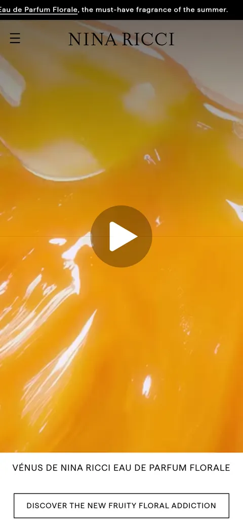 Nina Ricci on a mobile viewport: a full-screen fragrance film in warm amber tones beneath the Nina Ricci wordmark, with a Discover call to action